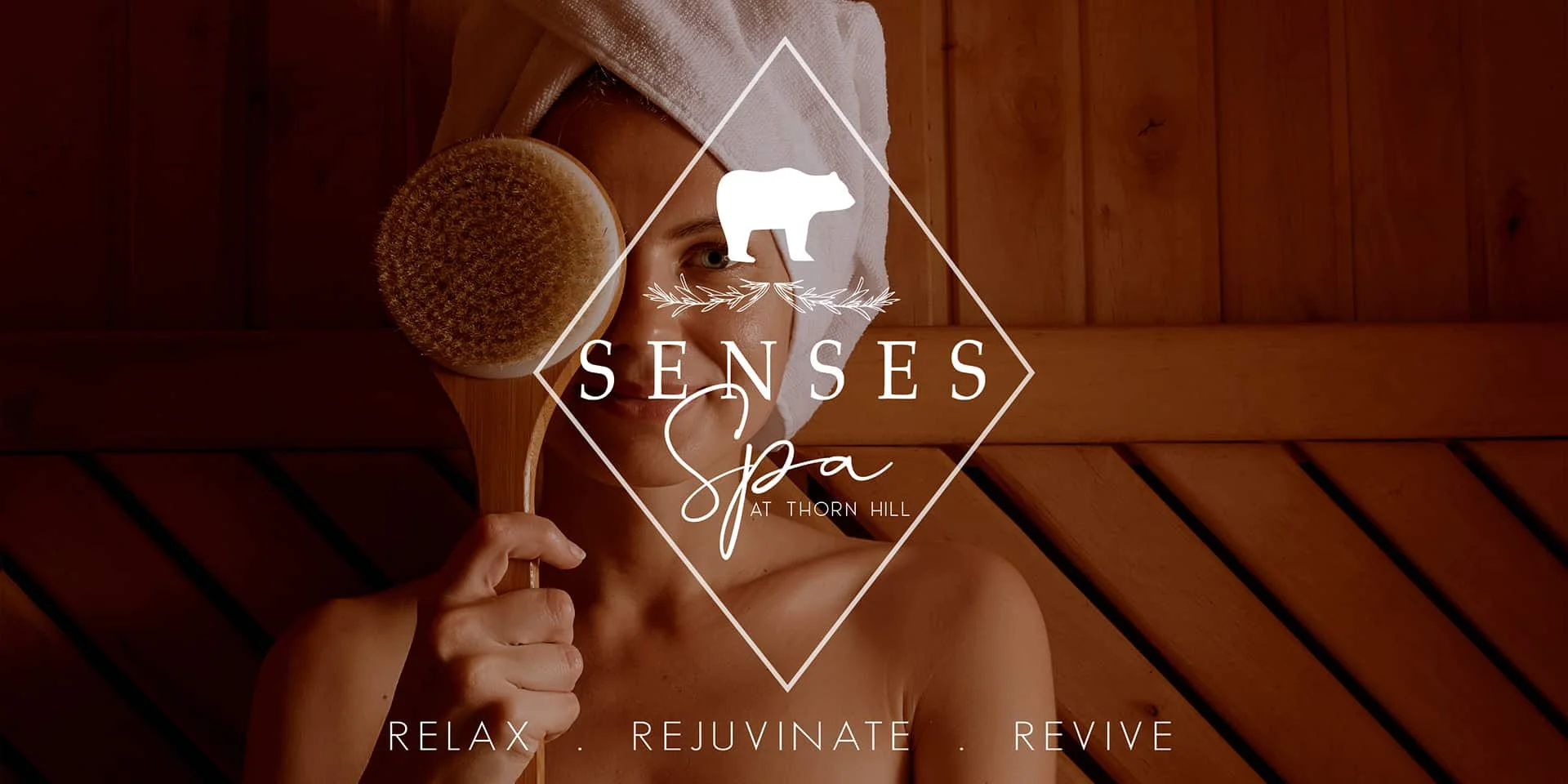 Women in sauna with towel over her hair, Inn at Thorn Hill Senses Spa logo over
